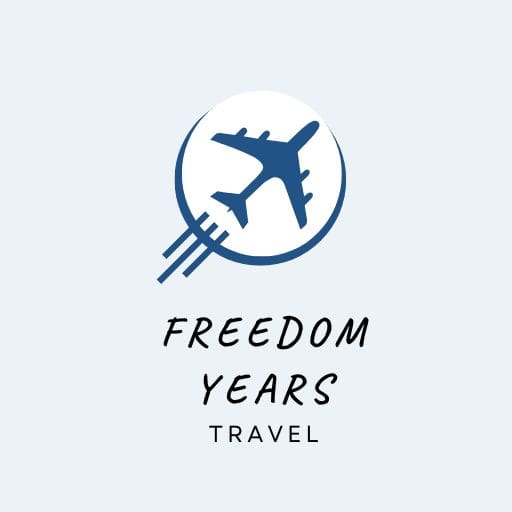 Logo for Freedom Years Travel featuring a blue airplane icon in motion above the words “FREEDOM YEARS” in bold font and “TRAVEL” in smaller text below.